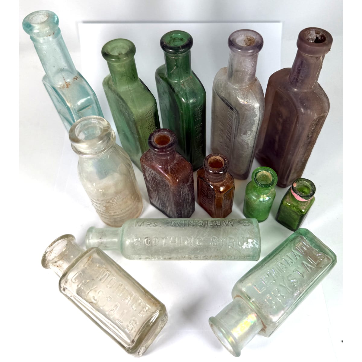 13 Bottles: 3 Poisons; Root Pills; Edison Battery Oil; Corn Cures; Lemonade Crystals; Marne & Co Sydney; Winslows and more.