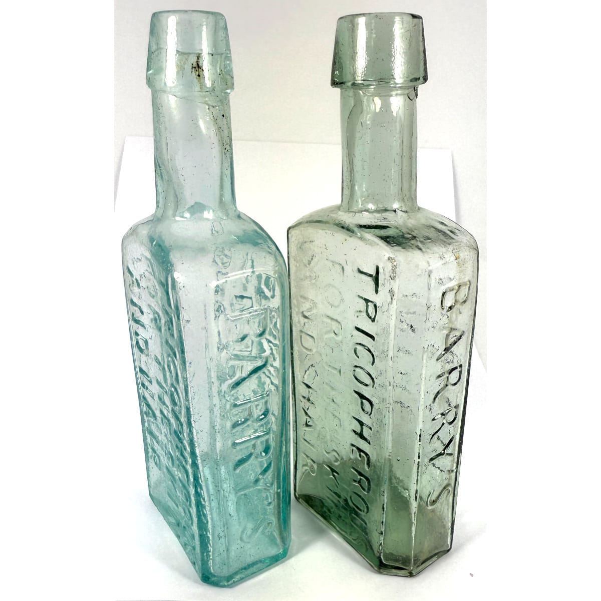 2 early Tricopherous for the Skin & Hair. Barry's New York. Pontil Scar to one and Cross Hinge mould to the other. 1850s - 1860s. 153 mm.