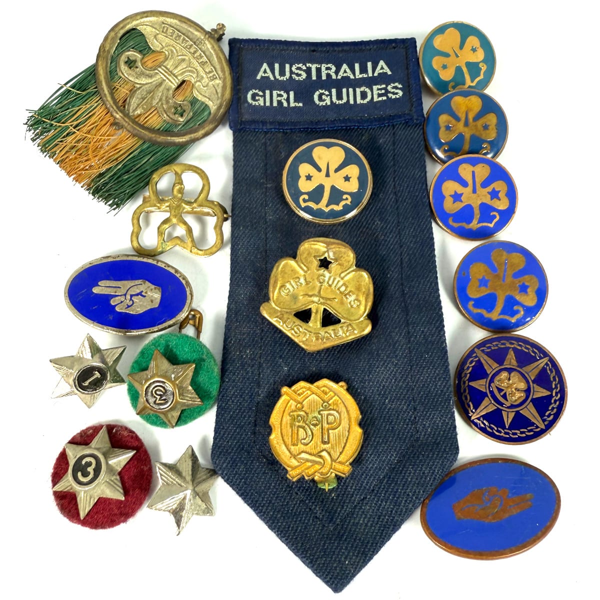 16 Girl Guides and Scouts badges. 3 of the Guides badges are on one sash. Enamel and metal ware.