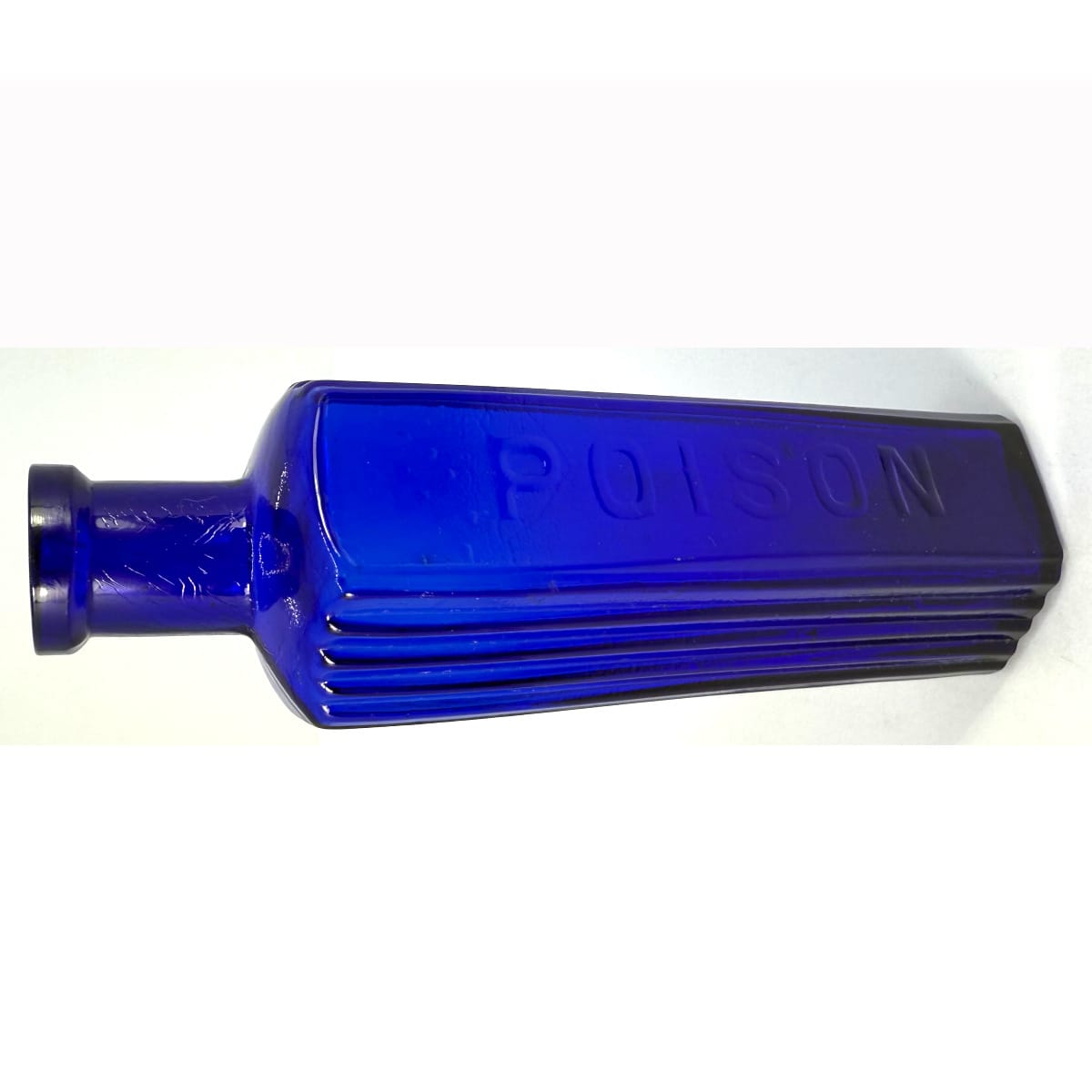 Poison. Hexagonal. Poison embossed on middle panel. Vertical ribs to two panels either side. Cobalt Blue. 4 oz. 139 mm.