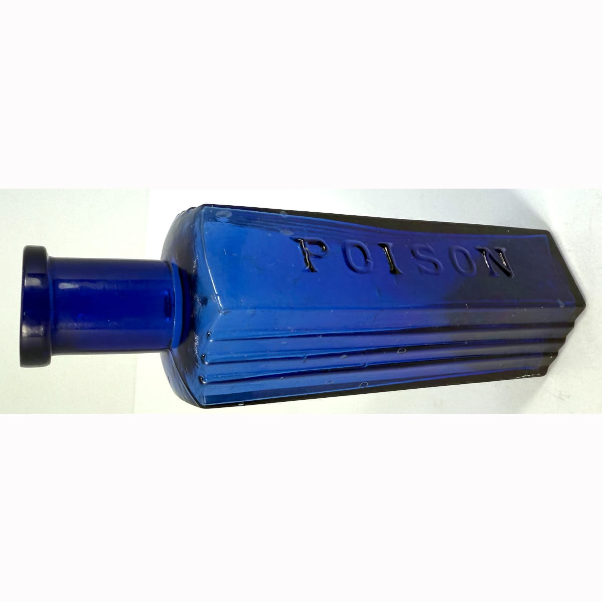 Poison. Hexagonal. Poison embossed on middle panel. Vertical ribs to two panels either side. Cobalt Blue. 3 oz. 127 mm.