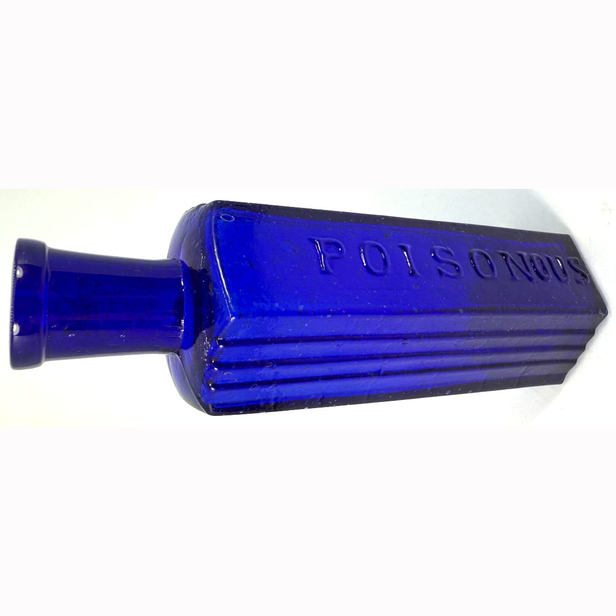 Poison. Hexagonal. Poisonous embossed on middle panel (and the ous has been added later to the mould). Vertical ribs to two panels either side. Cobalt Blue. 3 oz. 127 mm.