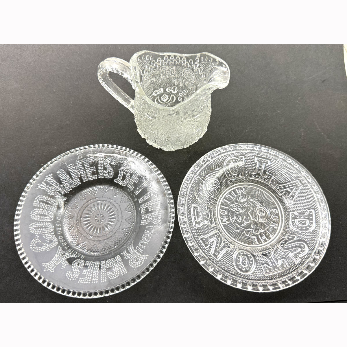 3 Pieces of pressed glass. Jug & Small plate with "Gladstone for the Million" and small plate "A Good name is better than riches".