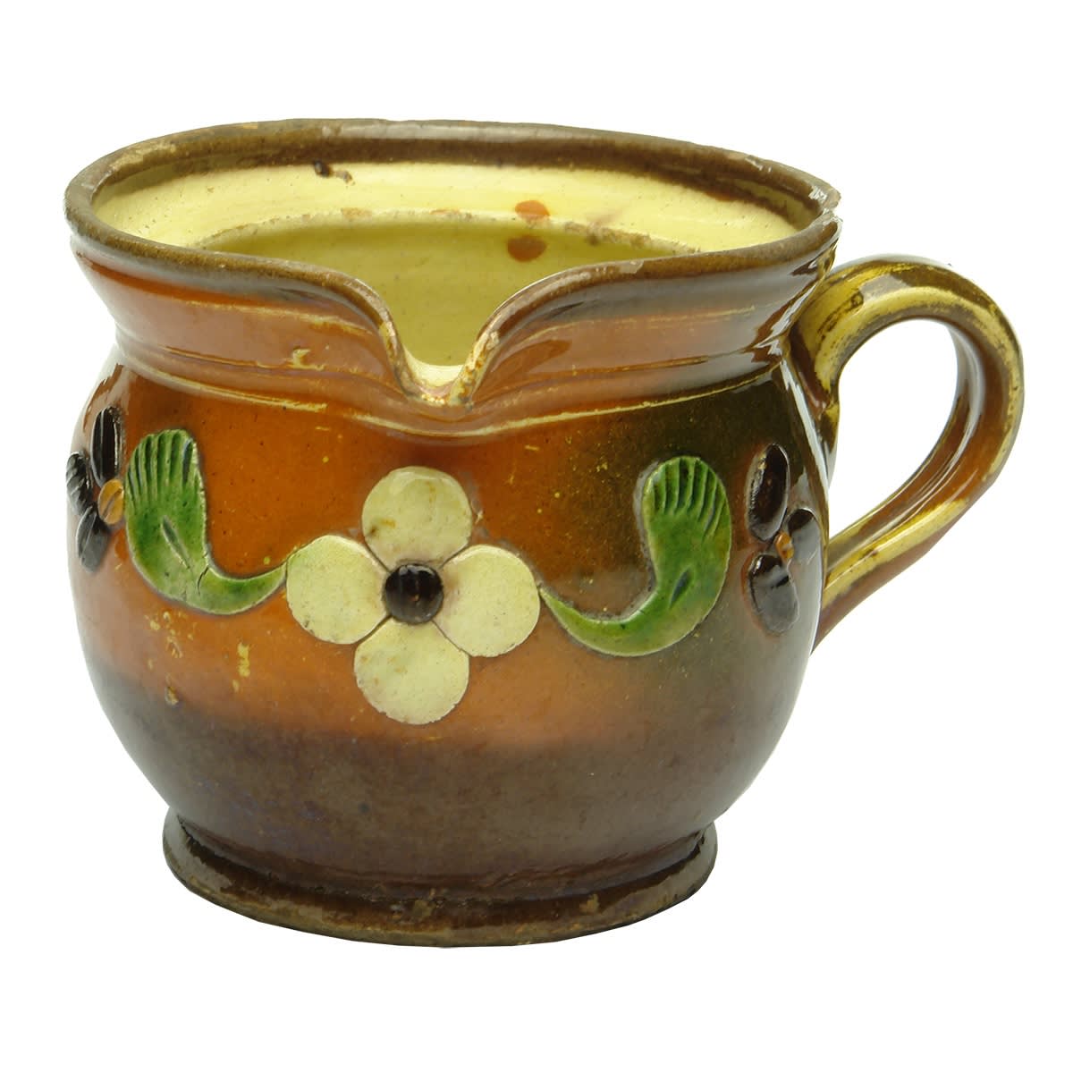 Small pottery mug with pouring lip. Orange/Brown and added decoration.