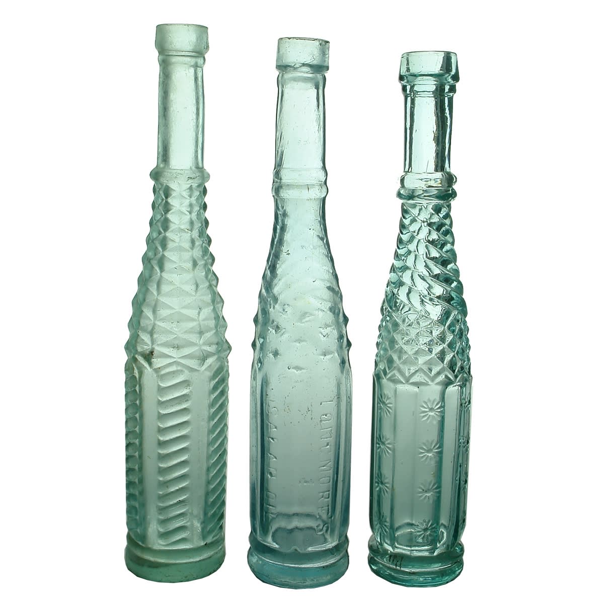 Salad Oils: 1. Whirley with Herringbone Pattern. Aqua. 5 oz. 2. Longmore's Salad Oil. Whirley. Aqua. 5 oz. 3. Whirley with Daisy Pattern. Aqua. 5 oz.