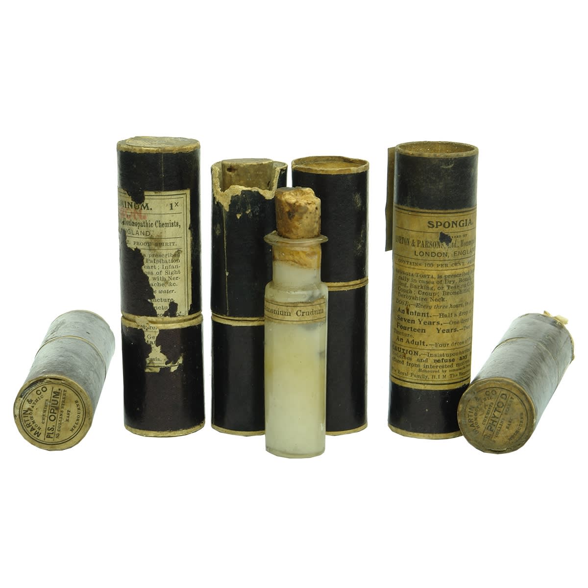 Medicine. 7 x early medicine vials and cardboard cases: 1. Martin & Co., Melbourne, Opium, Early vial inside with contents. 2. Ashton & Parsons, London, Labelled vial inside with some contents. 3. Unmarked case with labelled vial inside with contents from Launceston. 4. Martin & Co., Melbourne, Labelled early vial inside with contents. 5. Ashton & Parsons, London, Labelled Martin & Co., Melbourne vial inside. 6. Martin & Co., Melbourne, Embossed and labelled vial with some contents inside for Ashton & Parsons, London. 7. Vial only labelled Antimonium Crudum with contents.