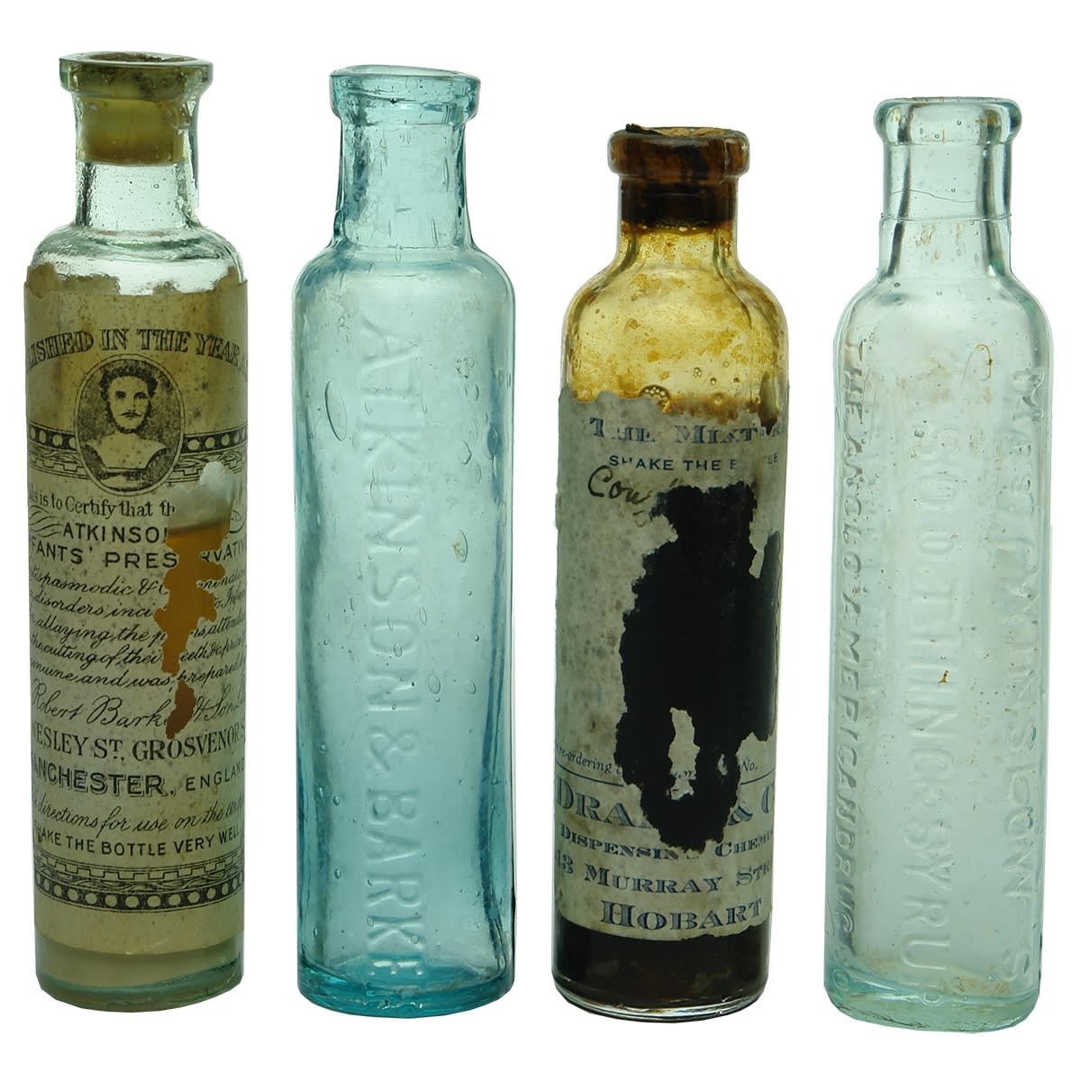 Medicine. Four Infant Cures: 1. Atkinson & Barker, Manchester. Labelled with Contents! Aqua. 2. Atkinson & Barker. Aqua. 3. Labelled Drake & Co., 43 Murray Street, Hobart bottle with contents. Clear. 4. Mrs. Winslow's Soothing Syrup. Aqua.