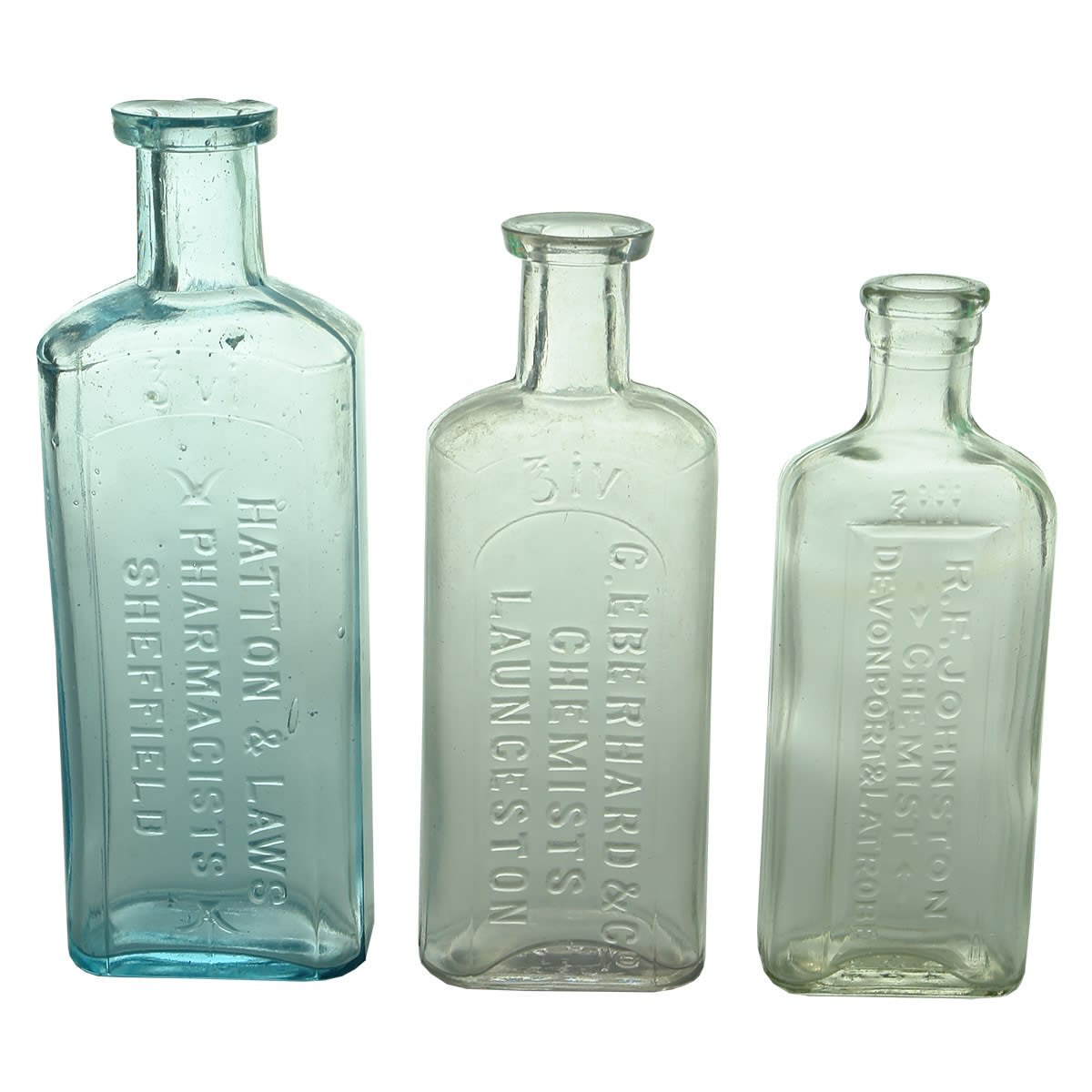 Chemists. Three northern Tasmanian chemist bottles: 1. Hatton & Laws, Sheffield. Aqua. 6 oz. 2. C. Eberhard & Co, Launceston. Clear. 4 oz. 3. R. F. Johnston, Devonport & Latrobe. Clear. 3 oz. (Tasmania)