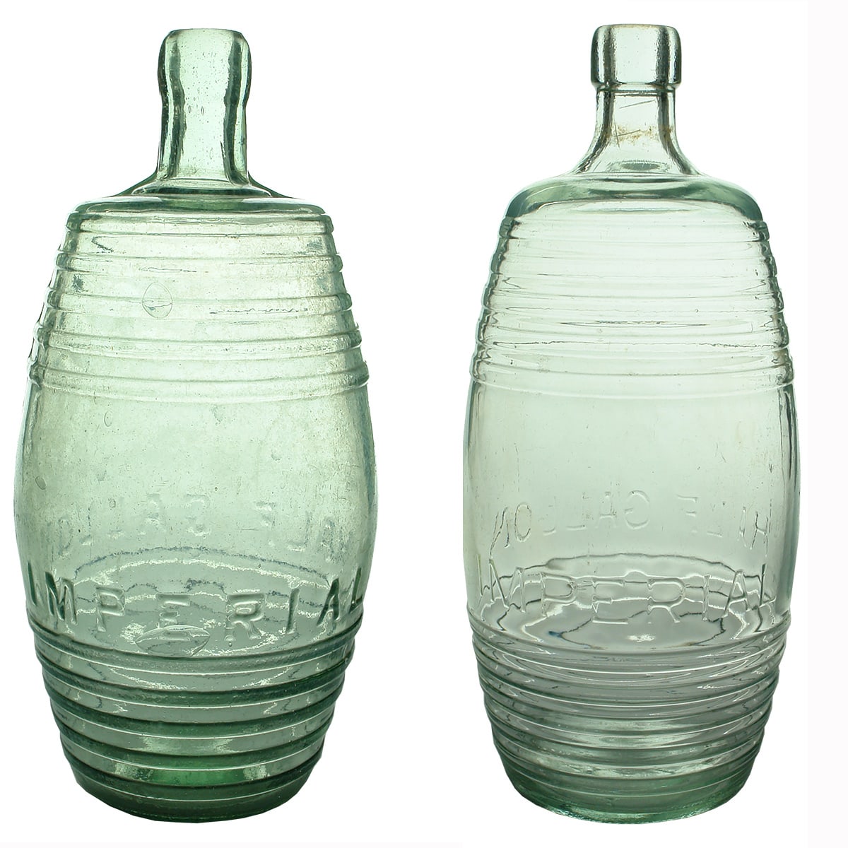 2 Imperial Half Gallon Barrel like bottles. A base mark and Modern AGM Monogram base mark.