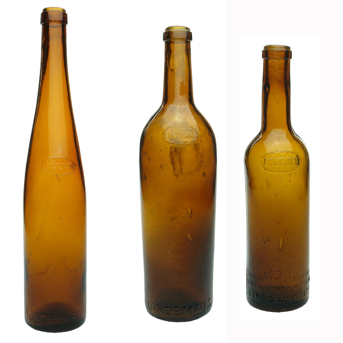 3 Lindemans Wine Bottles. Oval moulded "seals" on the shoulders. Amber. Hock, Claret & half sized Claret.