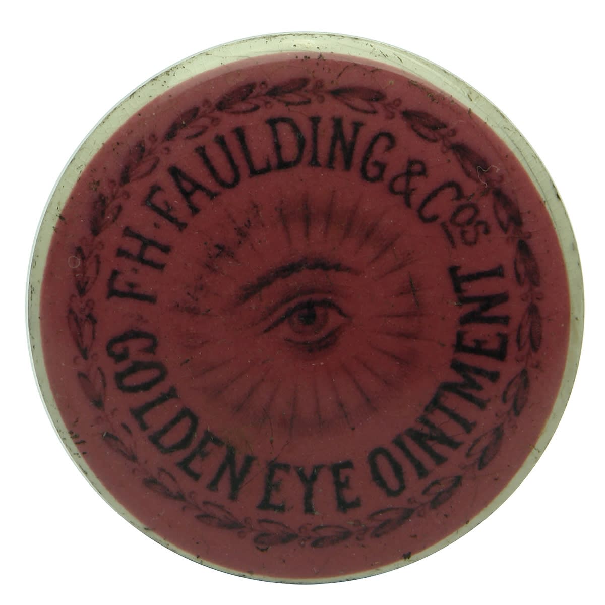 Pot Lid. F. H. Faulding & Cos, Golden Eye Ointment. Black on Pink. 48 mm diameter. (South Australia)
