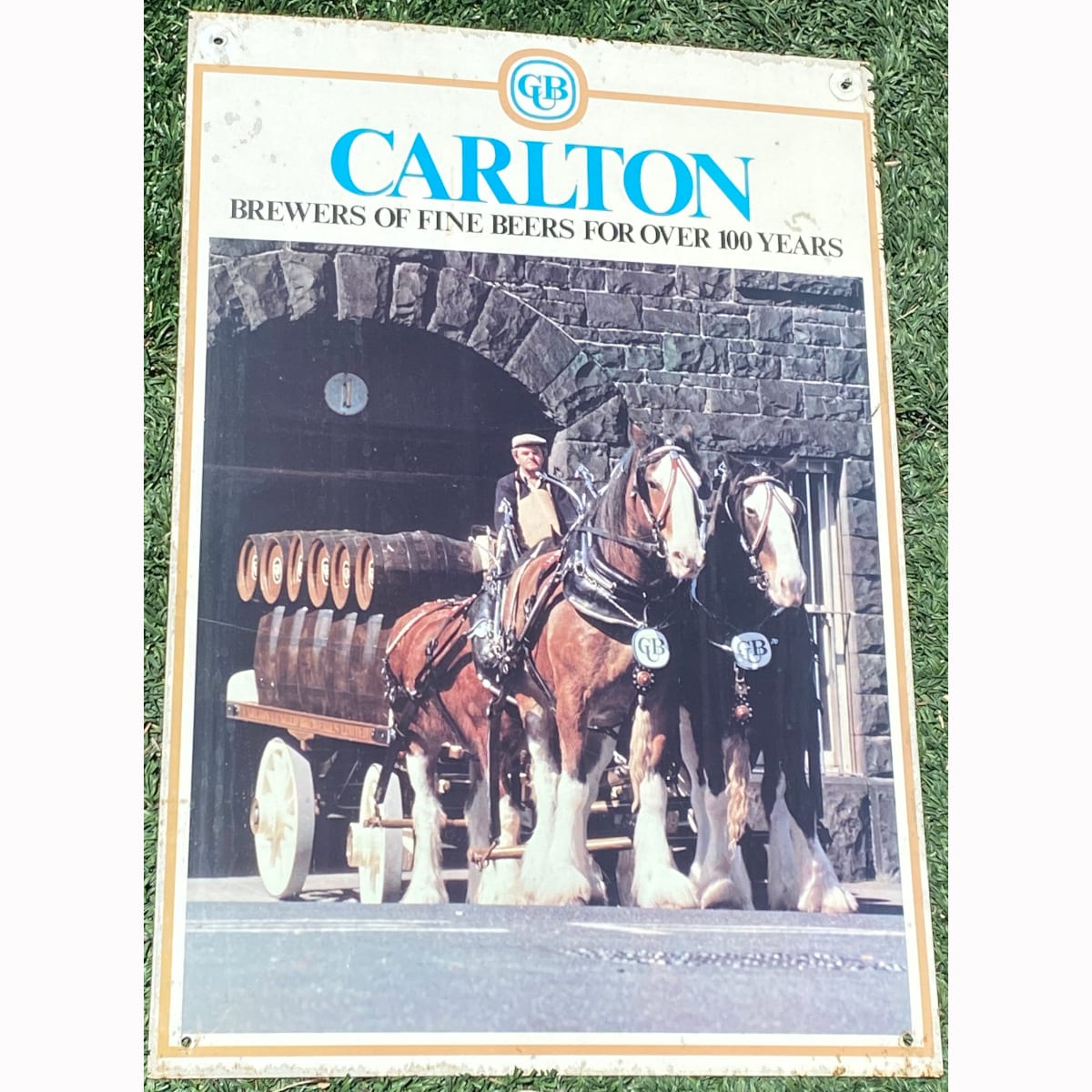 Tin Advertising sign. Carlton, Brewers of Fine Beers for over 100 years. Clydesdale team with cart, wooden barrels and blueston brewery building. (Carlton & United Breweries, Victoria)
