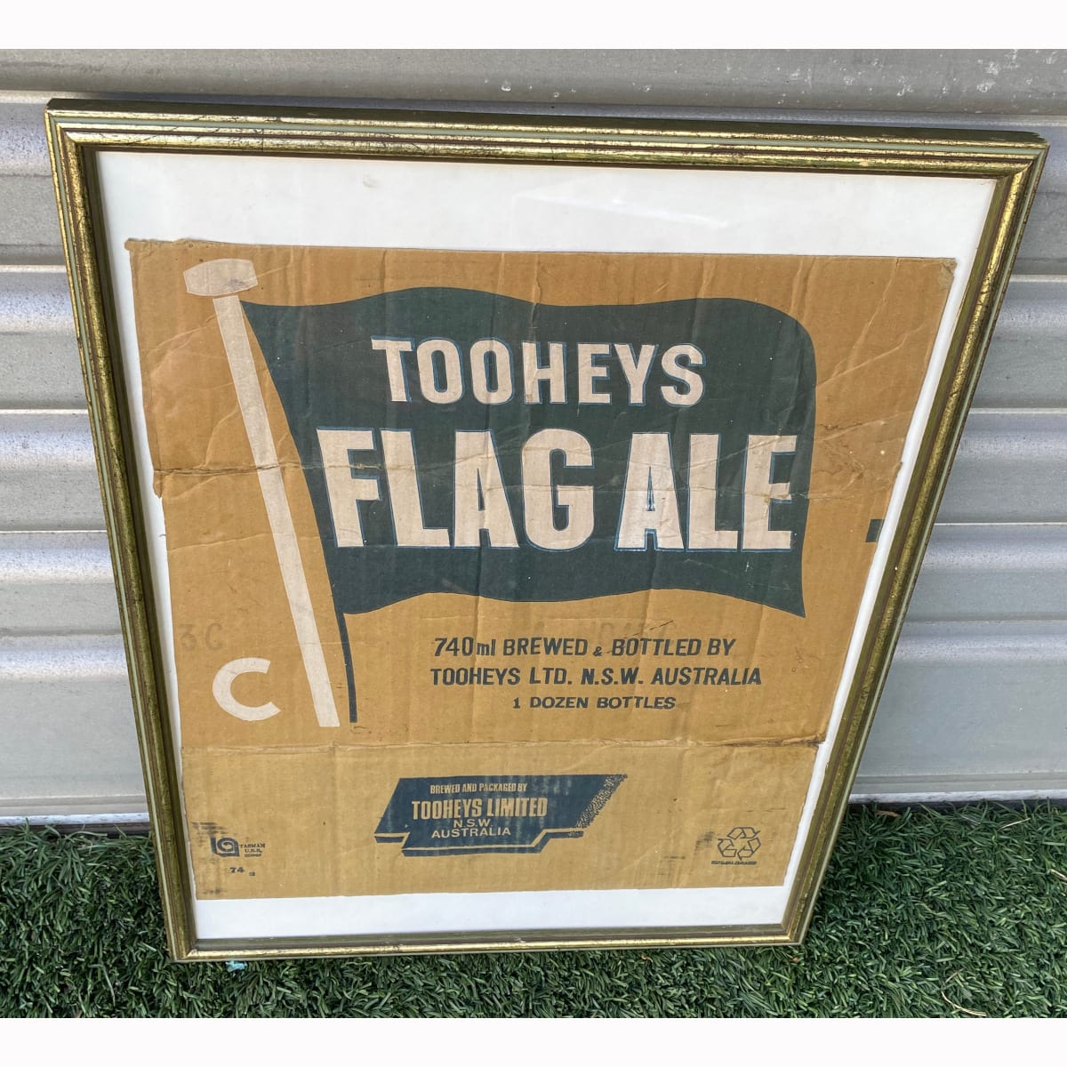 Framed cardboard box side for Tooheys Flag Ale. 1 Dozen 740 ml bottles. (Not for post. Arrangements will have to be made by winning bidder for pickup or courier delivery)  (New South Wales)