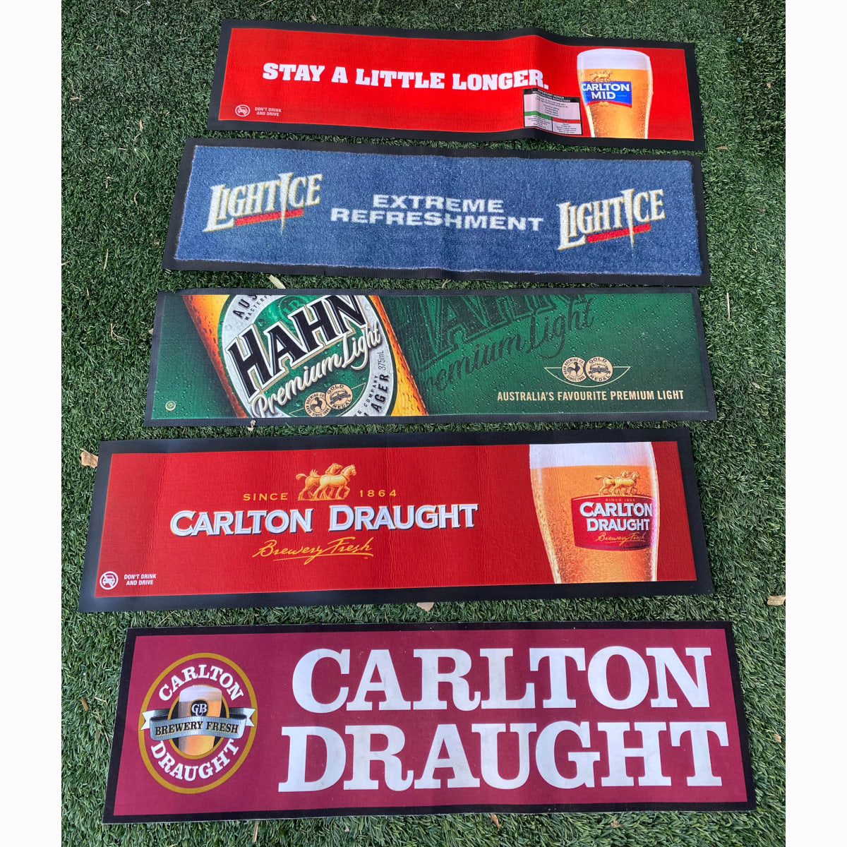 5 rubber backed bar mats: Carlton Mid; Light Ice; Hahn Premium Light; 2 x different Carlton Draught.