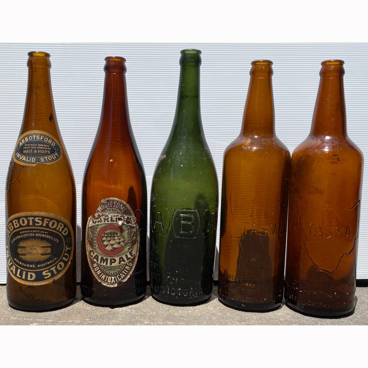 5 Beer Bottles: Green ABA; 2 x Tasma; 2 x MBCV with original labels Carlton Camp Ale; Abbotsford Invalid Stout.