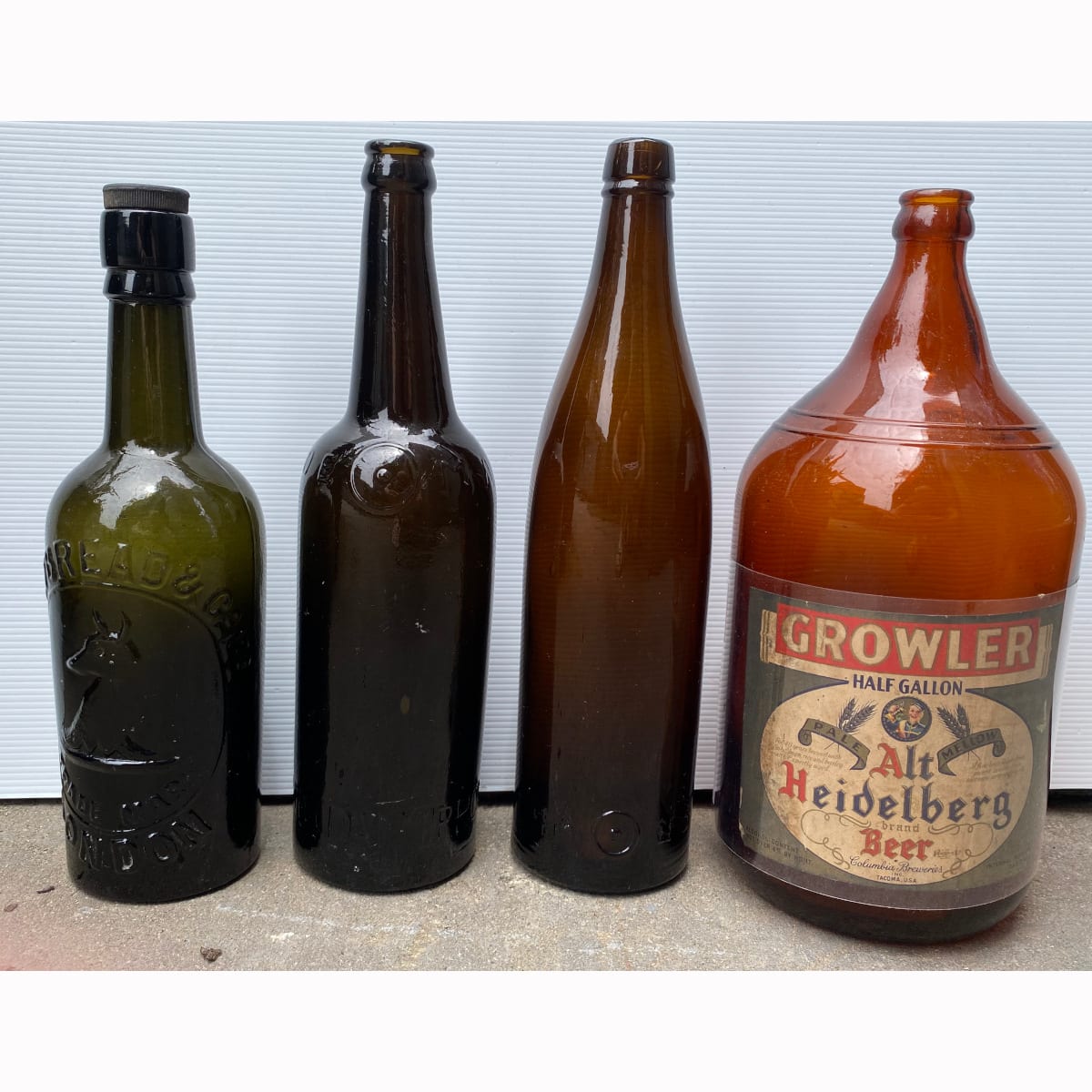 4 International Beer Bottles: Dai Nippon Brewery; Japanese amber tapered bottle; Whitbread & Co Ltd London; Large "Growler" half Gallon. Alt Heidelberg Beer. Columbia Breweries Tacoma USA.