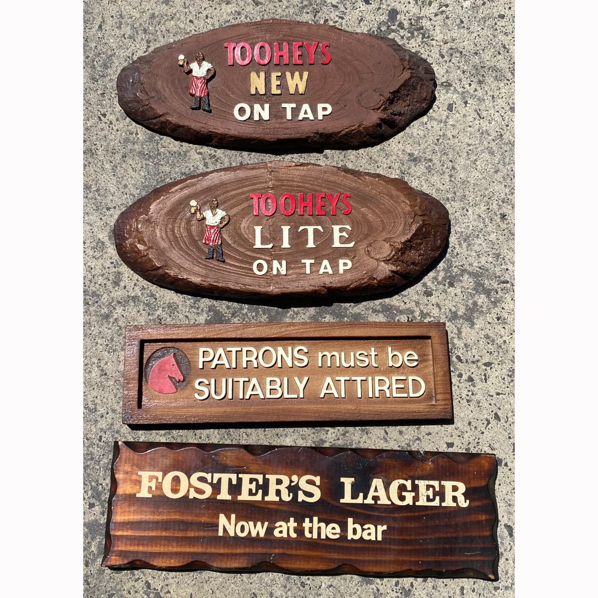 4 small bar signs: Tooheys New on Tap; Tooheys Lite on Tap; Tooth Logo, Patrons must be suitably attired; Foster's Lager now at the bar.