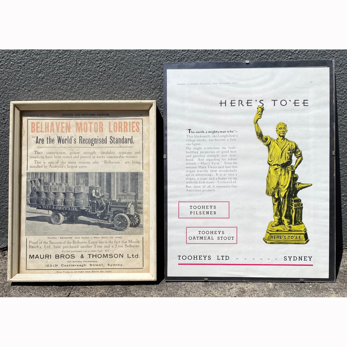 2 Framed Advertisements: Here's To'ee Tooheys Limited Sydney, Blacksmith; Belhaven Motor Lorries, Mauri Bros & Thomson Ltd Sydney Featuring Reschs Limited lorry with barrels and wicker baskets. (New South Wales)