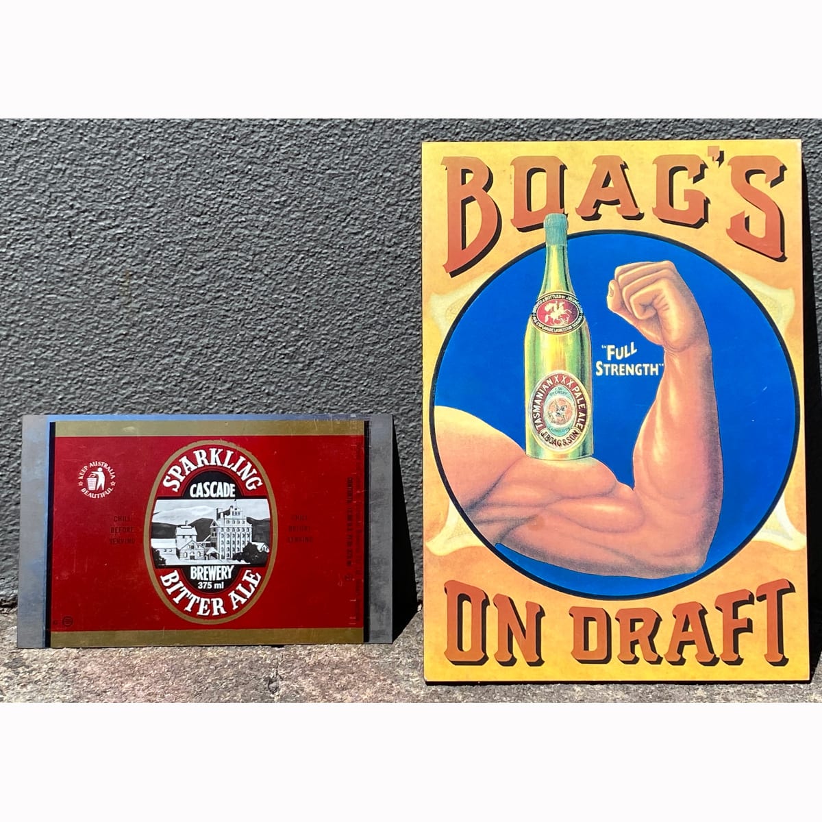 2 Tassie Pieces: Print on board for Boag's On Draft. Bottle on mans bicep - Full Strength; Unmade can of Cascade Sparkling Bitter Ale. Size in US ounces and mls. (Tasmania)