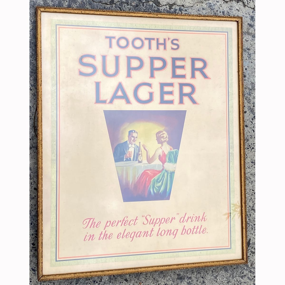 Framed original Cardboard Advertising Sign. Tooth's Supper Lager. In the elegant long bottle. Man and woman at a table with a bottle of Tooth's Supper Lager. (Carlton Hotel Albury on back in pencil) (New South Wales) (Not for post. Arrangements will have to be made by winning bidder for pickup or courier delivery)