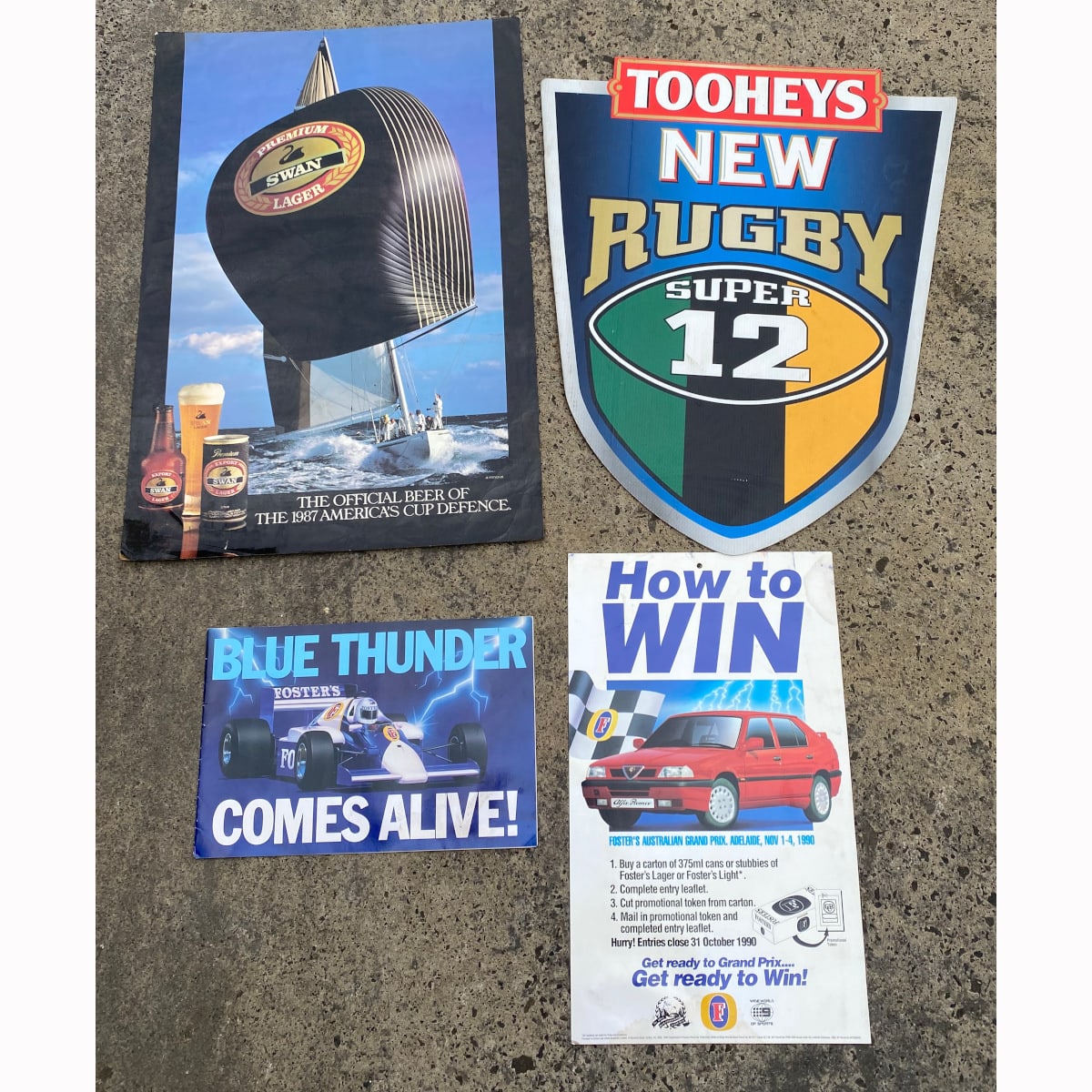 4 Pieces sports related beer Advertising: Swan Lager 1987 America's Cup Poster; Tooheys New Super 12 Rugby Corflute shield; 1986 Foster's Grand Prix booklet for liquor stores; 1990 Foster's Grand Prix poster. (Not for post. Arrangements will have to be made by winning bidder for pickup or courier delivery)
