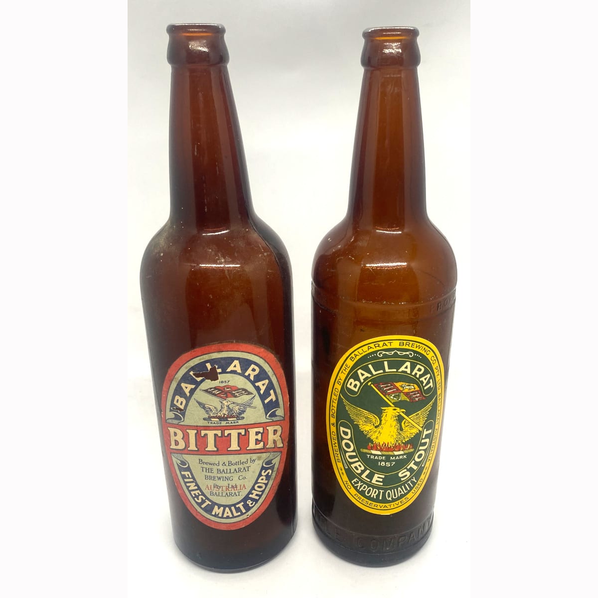 2 Labelled beer bottles: First one looks like original Ballarat Bitter on a plain shouldered crown seal beer; Second one is a new old stock Ballarat Double Stout stuck on a 1938 NSW Bottle Company bottle in recent times. Ballarat Brewing Co Pty Ltd.