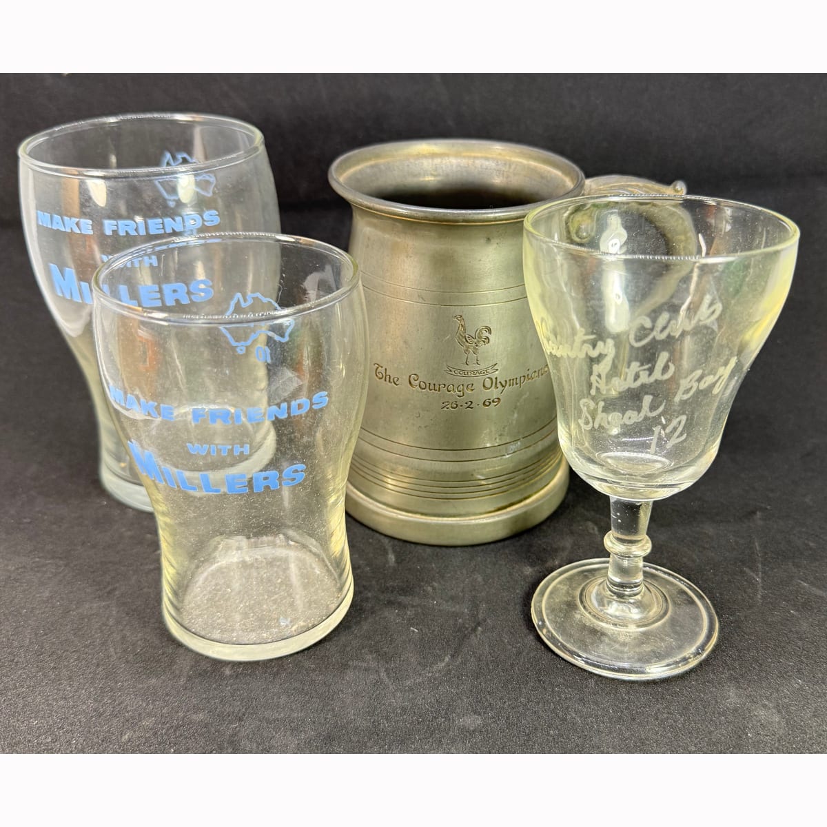 4 Glasses/Mugs: Small and Medium Glasses "Make Friends with Millers"; Country Club Hotel Shoal Bay wine glass; The Coutage Olympians 26/2/69 pewter mug.