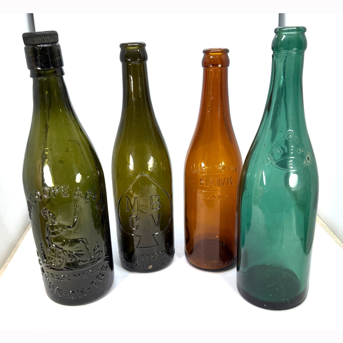 4 Mid sized Beer Bottles: Ind. Coope & Co Ltd Burton on Trent; MBCV; Bier Crown Seal; Consolidated Brewery Ltd Napier.