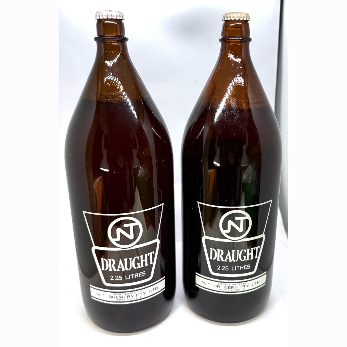 2 Darwin Stubbies: NT Draught, N. T. Brewery Pty Ltd Darwin. One with label for Back to Darwin, 1978, Darwin Stubby.
