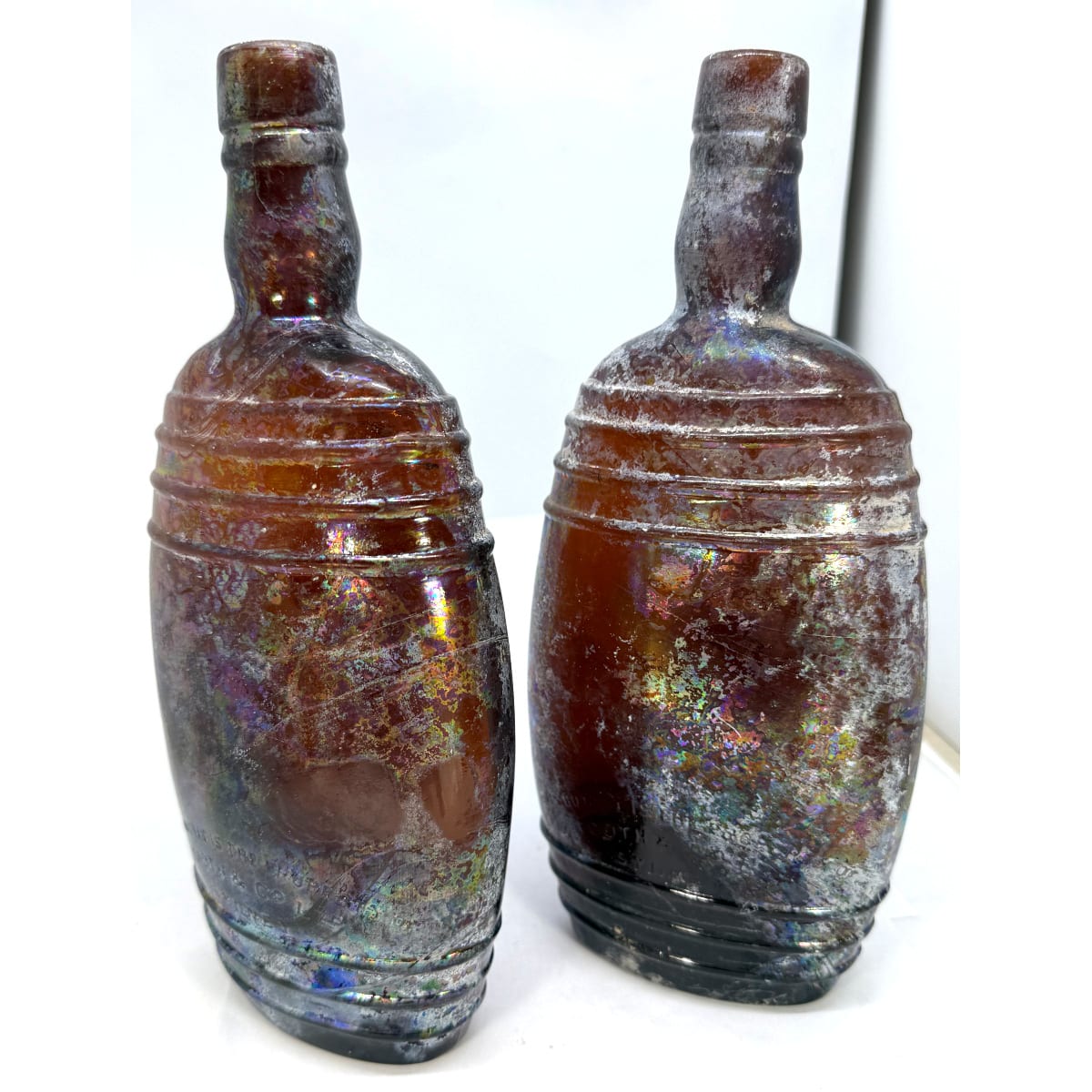 2 Tooth & Co Ltd Sydney Rum Bottles. Flattened barrel shapes. Amber. 26 oz. (New South Wales)