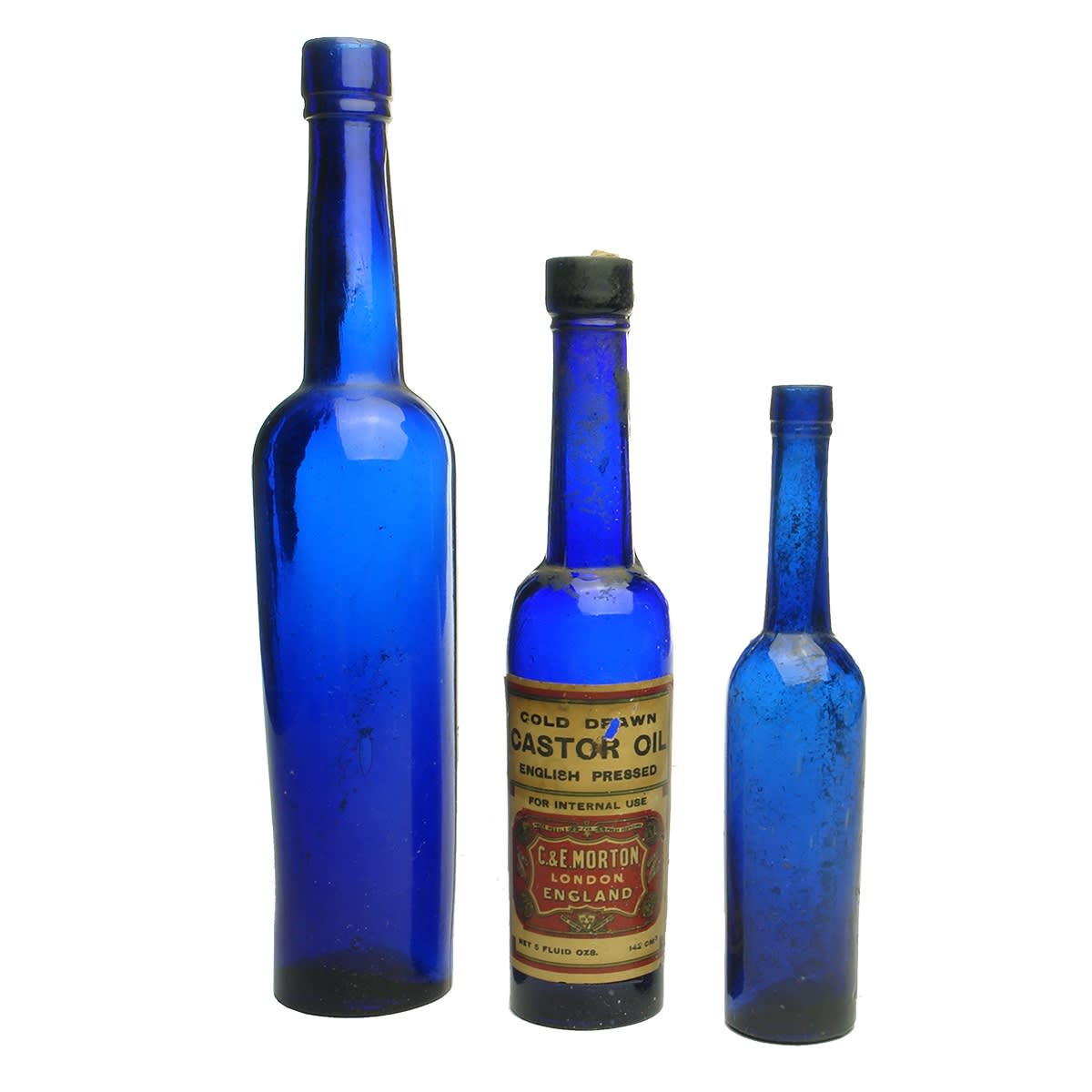 Castor Oil. 7 x cobalt castor oils: 1. Plain 10 oz. 2. Labelled C. & E. Morton, London, England, Cold Drawn Castor Oil with half contents, 5 oz. 3. Plain 2 oz. 4. Plain 5 oz. 5. Plain 5 oz. 6. Plain 5 oz. 7. Plain 5 oz.