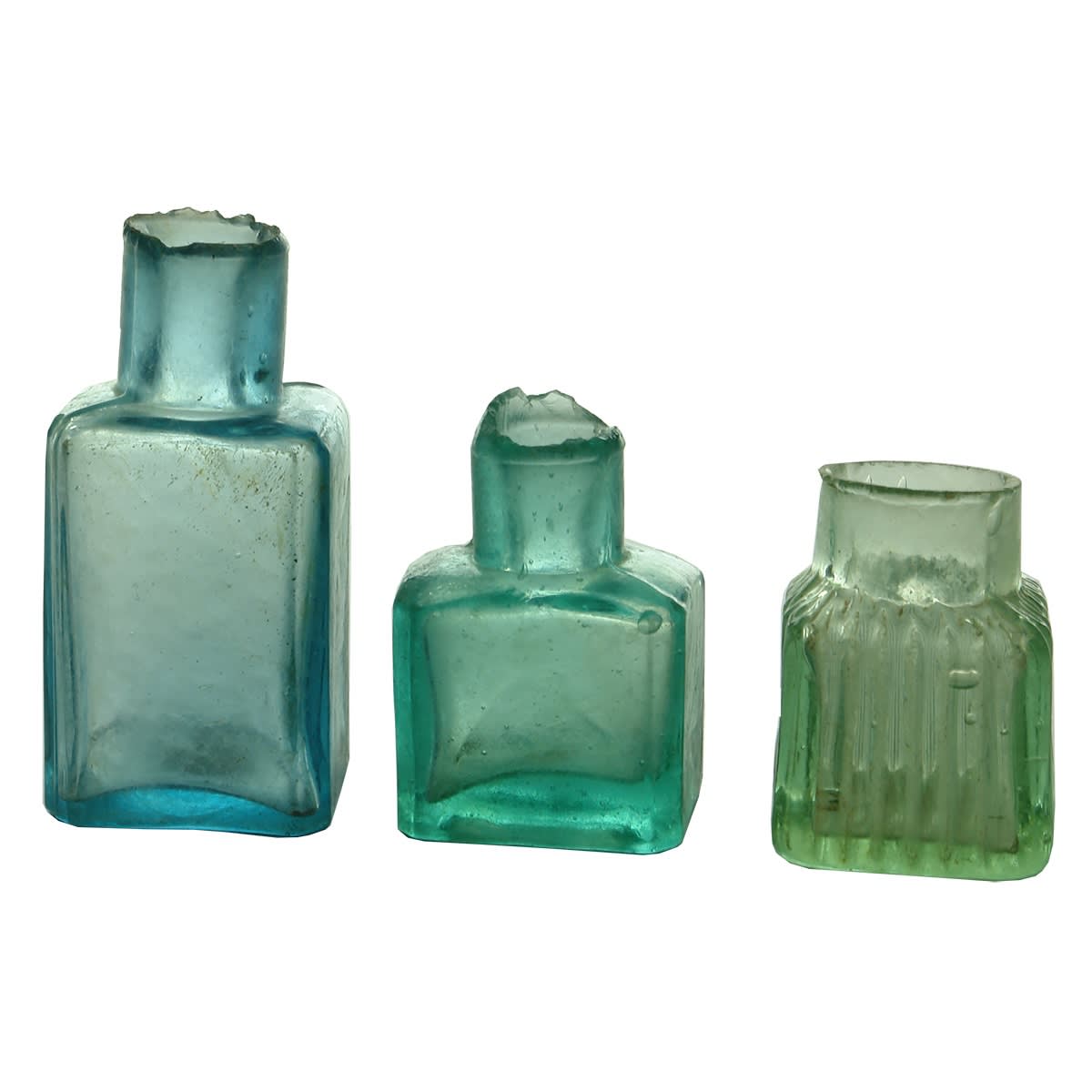 Inks. Six inks/gums: 1. Larger ice blue unmarked gum. 2. Squat unmarked gum. 3. Unusual small square wide mouth ink with heavy ribs throughout. 4. Blue octagonal ink. 5. Round aqua ink. 6. Square clear cabin ink.