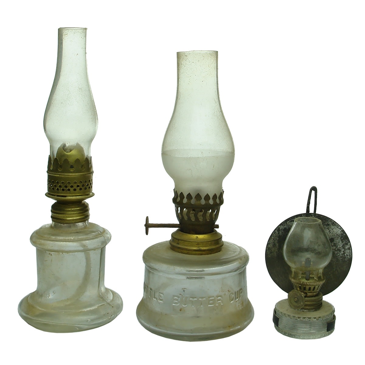 Lamps: 1. Clear unmarked lamp with Nutmeg, England burner. 2. Little Butter Cup. Clear. 3. Tiny lamp with reflector. Clear.