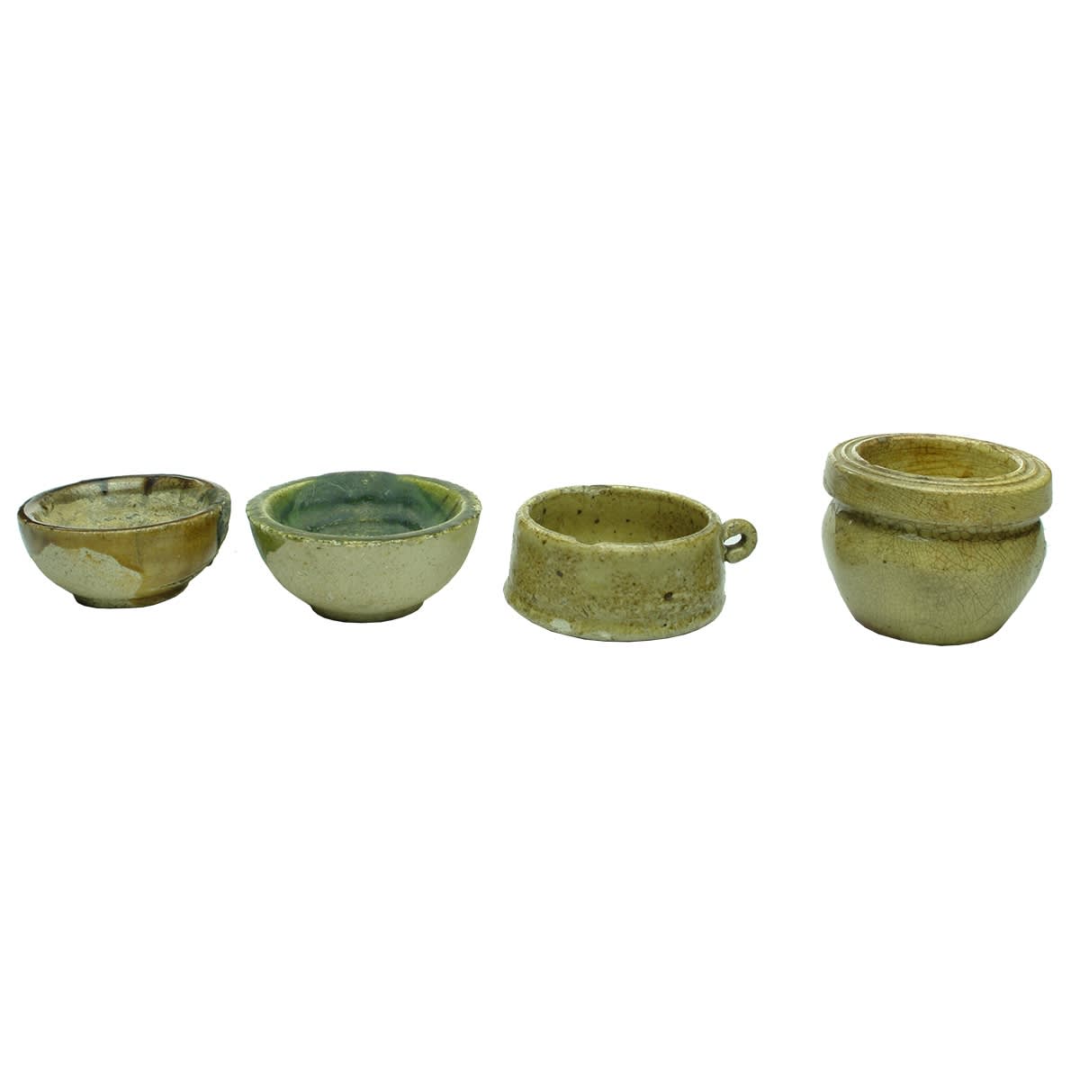 Pottery. 1. Battersea Crucible, 2 1/2. 2. Battersea Crucible, 2 3/4. 3. Small handled item. 4. French pot. 5. Needham's Polishing Paste, Sheffield. 6. Flat salt glaze dish. 7. Ceramic knob. 8. Ceramic knob. 9. Ceramic thing. 10. Ceramic knob with metal fitting.