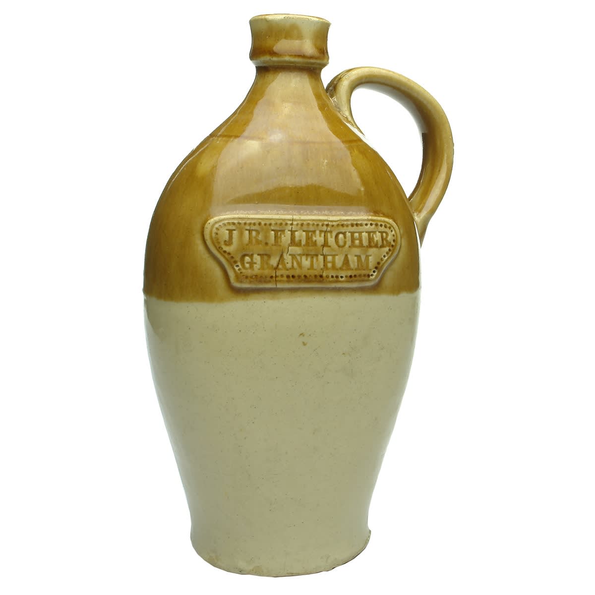 Slab seal whisky jug. J. R. Fletcher, Grantham. Flat sided tan top pedestal shape. Handle. (UK)
