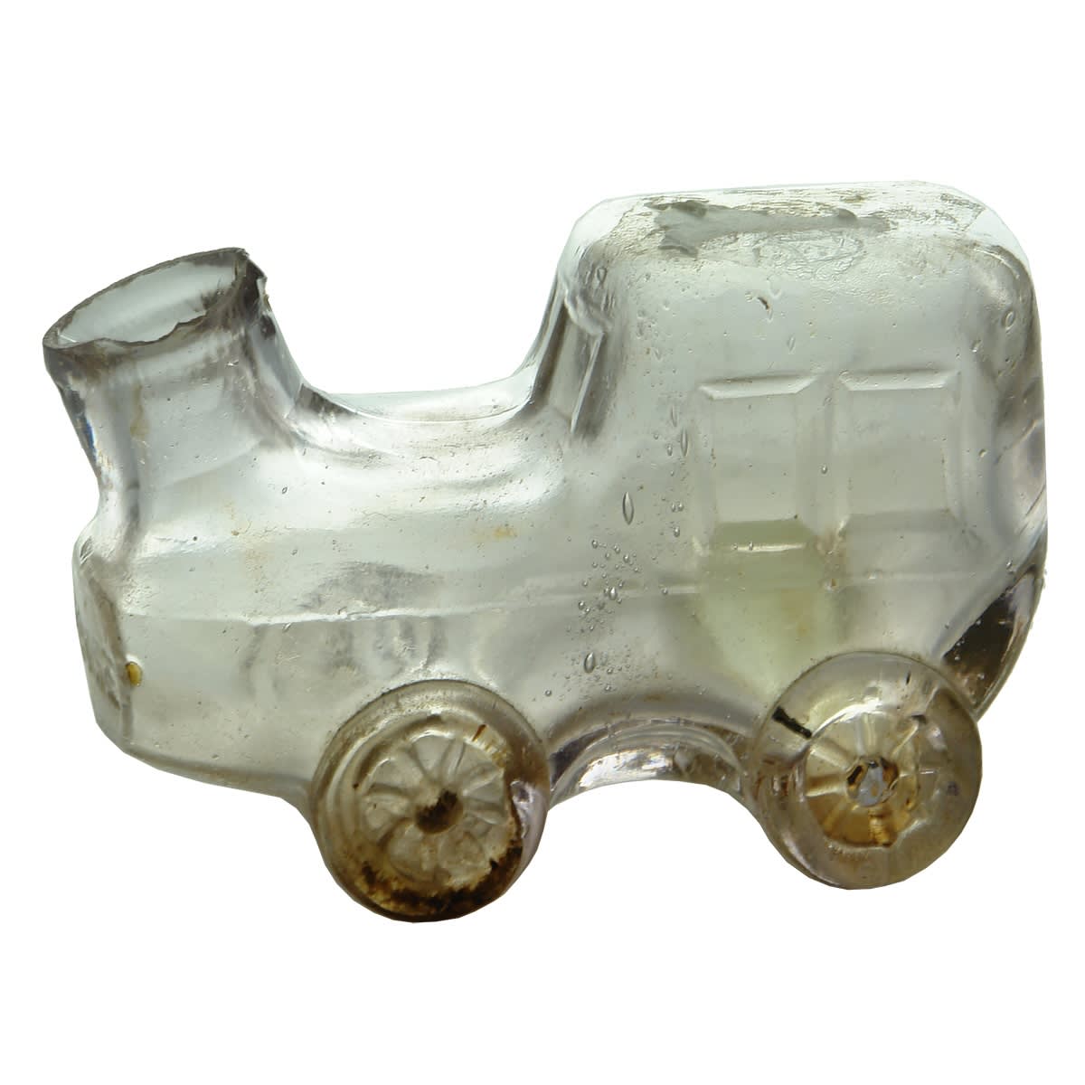 Ink. Figural in the shape of a car or carriage. Shear lip. Clear (very pale amethyst). 86 mm long.