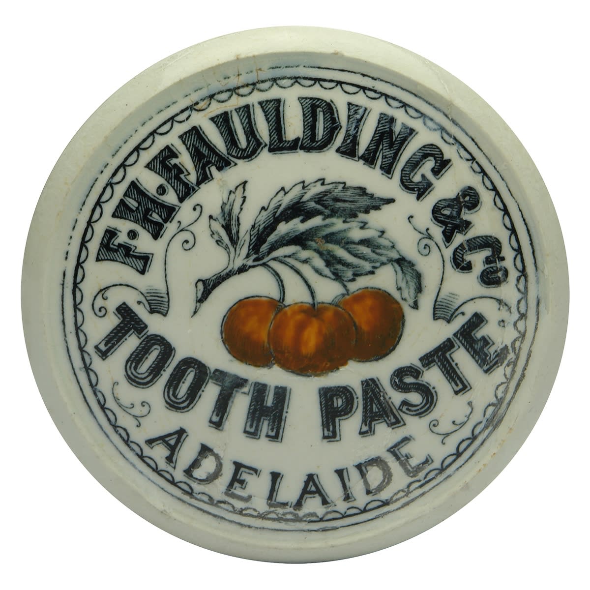 Pot Lid. F. H. Faulding & Co., Adelaide. Tooth Paste. Hand painted red cherries. Queens Head shaped lid. 79 mm diameter. With a matching base. (South Australia)