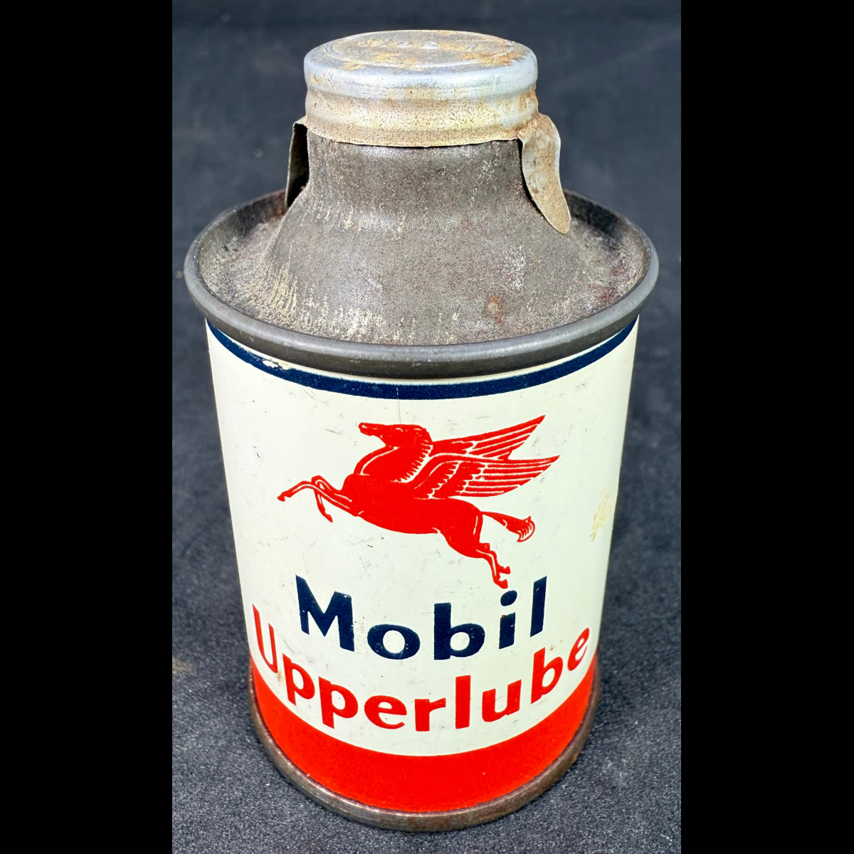 Small oil tin. Mobil Upperlube. French & German(?) Instructions. 1 dose for 20 Litres of fuel. (Not for standard post due to contents. Winning bidder will have to make other arrangements to collect)