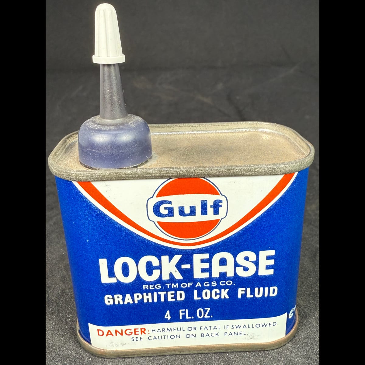 Small tin. Gulf Lock-Ease. Graphited Lock Fluid. 4 oz. Gulf Tire & Supply Company. Gulf Building Houston Texas.  (Not for standard post due to contents. Winning bidder will have to make other arrangements to collect)