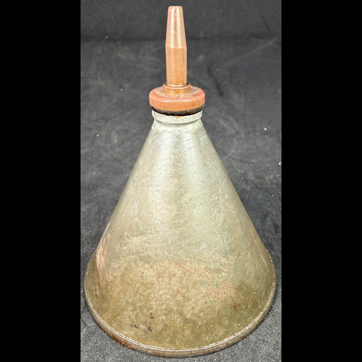 Plain conical tin oiler. Brass top.