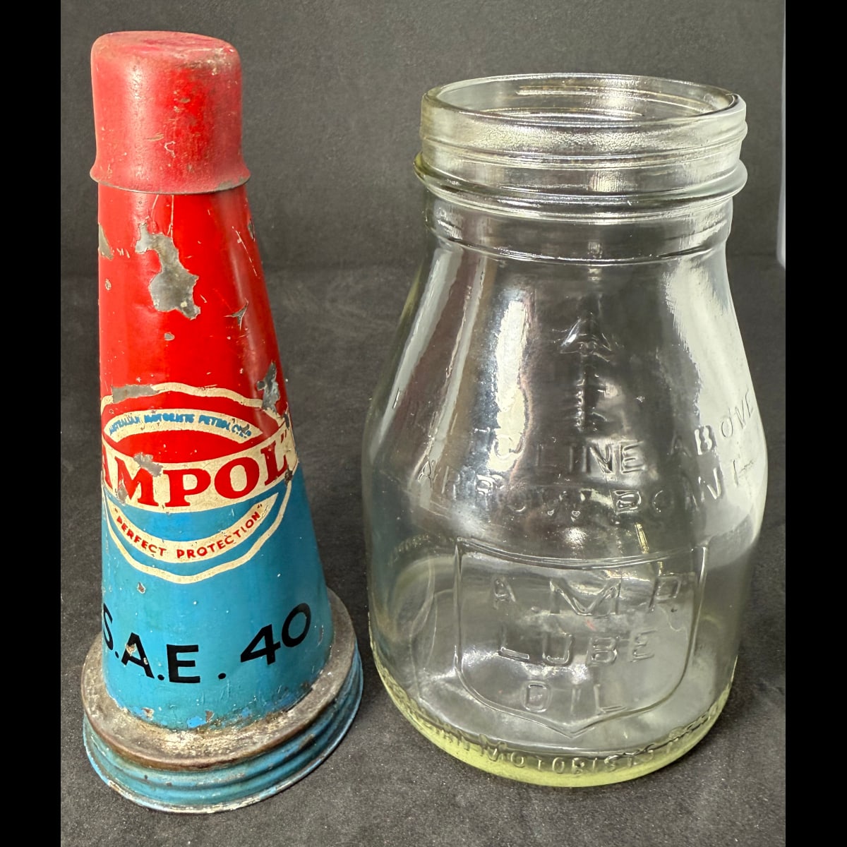 Tin oil top pourer and original AMP Pint Bottle. Australian Motorists Petrol Co AMPOL Tin top. Pint bottle also Australian Motorists Petrol Co. A. M. P. Lube Oil.
