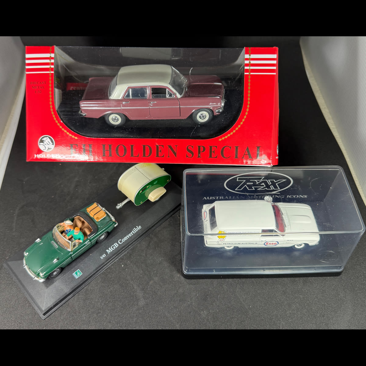 3 Model Cars with Packaging: EH Holden Special; MGB Convertible with Caravan; Falcon XK Panel Van with Esso Petroleum Australia Drip Man advertising.