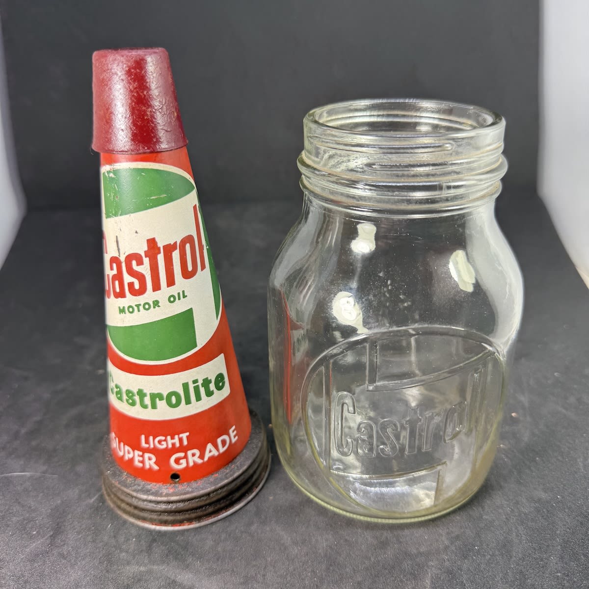 Tin oil top pourer. Castrol Motor Oil Castrolite. Light Super Grade. Castrol branded glass pint bottle. Property of Castrol Limited.