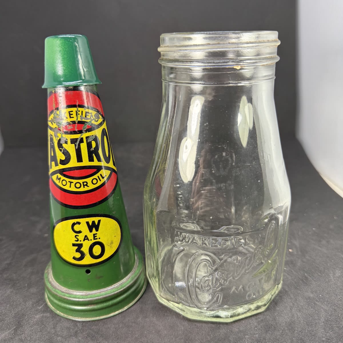 Tin oil top pourer and embossed bottle. Wakefield Castrol Motor Oil. C. C. Wakefield & Co pint bottle.