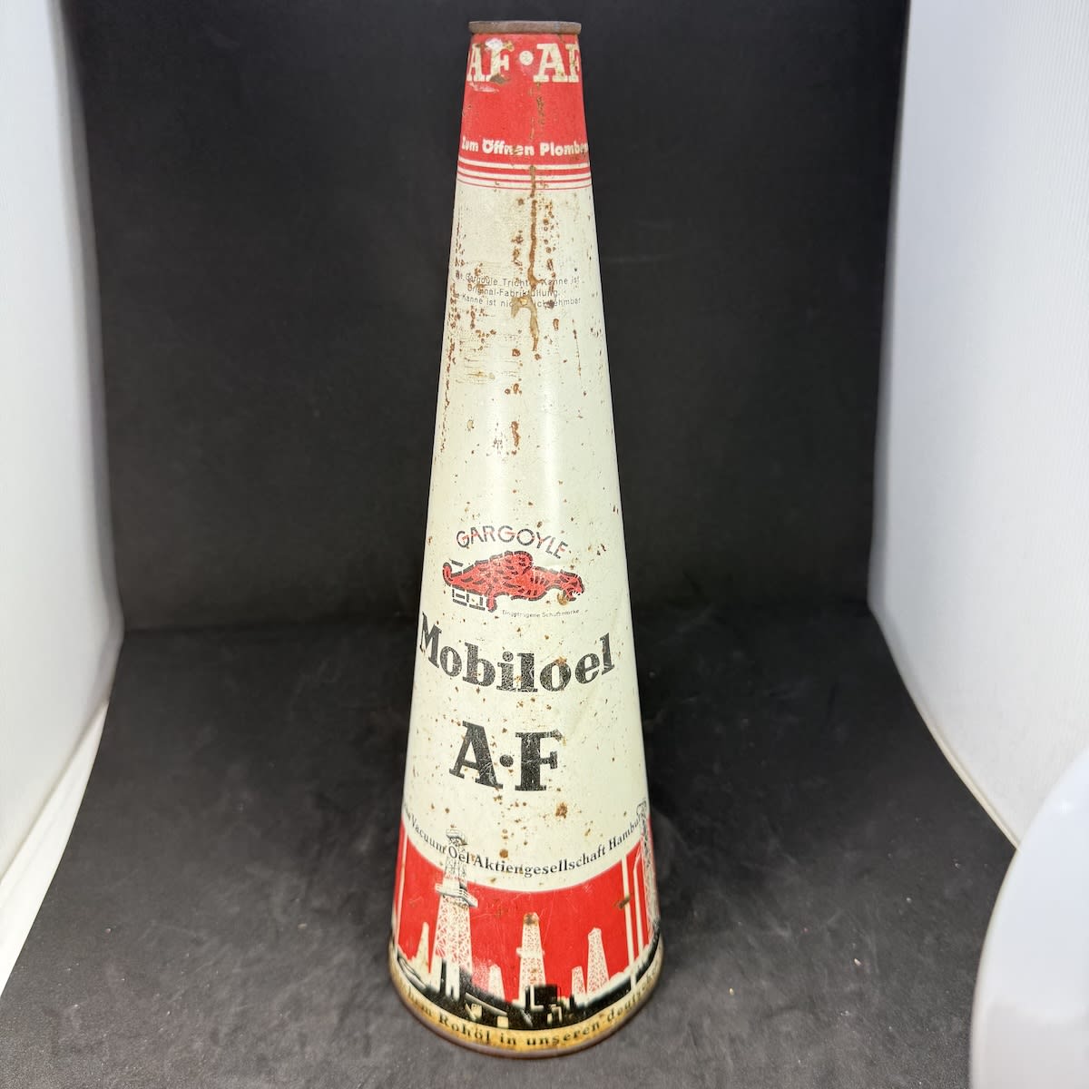 All Tin Conical Oil Bottle. German. Gargoyle. Mobiloel. AF. Vacuum Oil Hamburg. (Not for standard post due to contents. Winning bidder will have to make other arrangements to collect)