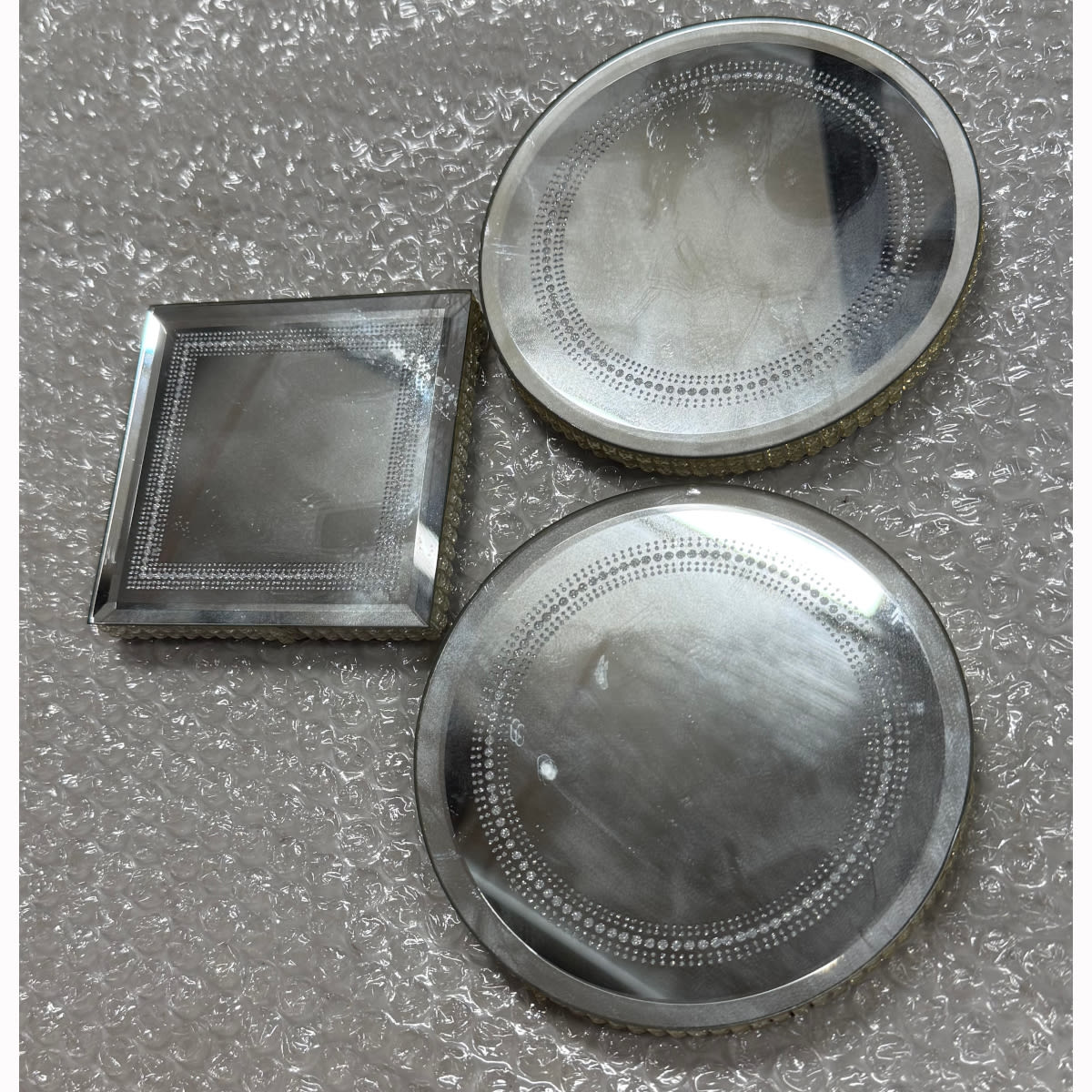 Three mirrored bases for display.