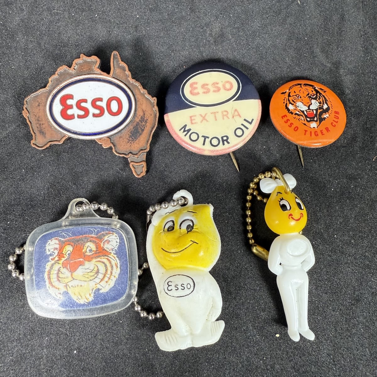 6 small ESSO promotional items: 3 keyrings and 3 badges. Drip People; Esso Tiger Club; Put a Tiger in your tank; Australia Esso badge.