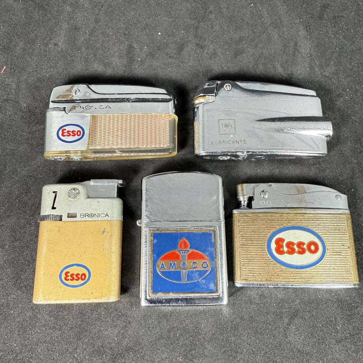 5 promotional lighters: 3 different Esso branded; Amoco; BP Lubricants.