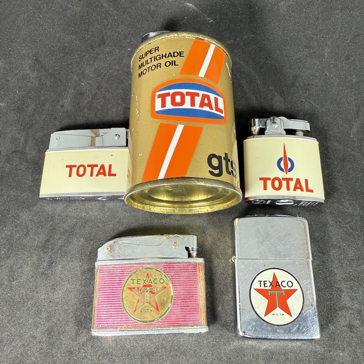 5 advertising lighters: 3 different Total including oil tin shaped; 2 different Texaco.