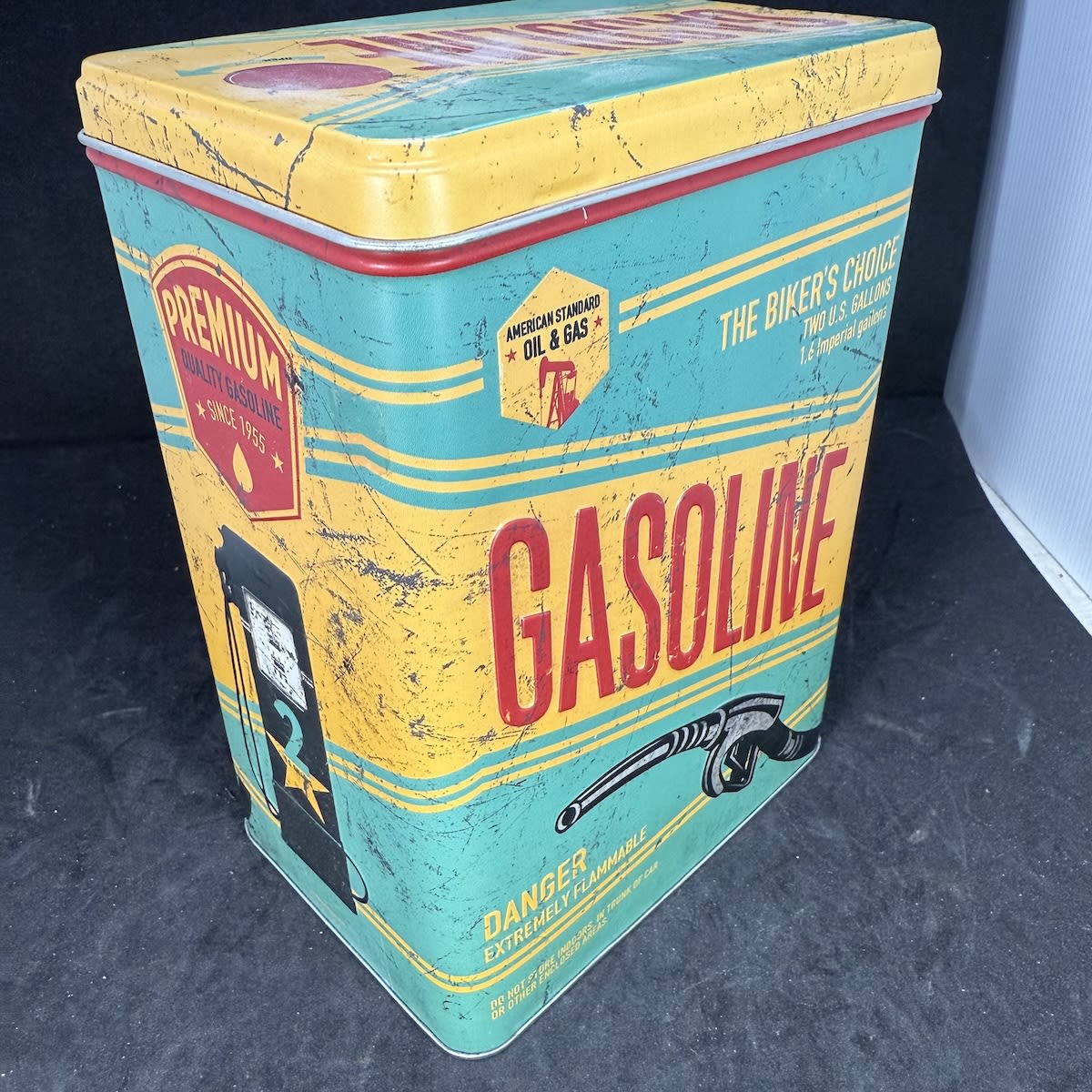 Tin with some random contents: The Biker's Choice storage tin shaped like a Gasoline tin. Glass Jar. 2 Plastic pourers. 1 metal & 3 plastic dust caps. Mobil battery sticker cut in two.